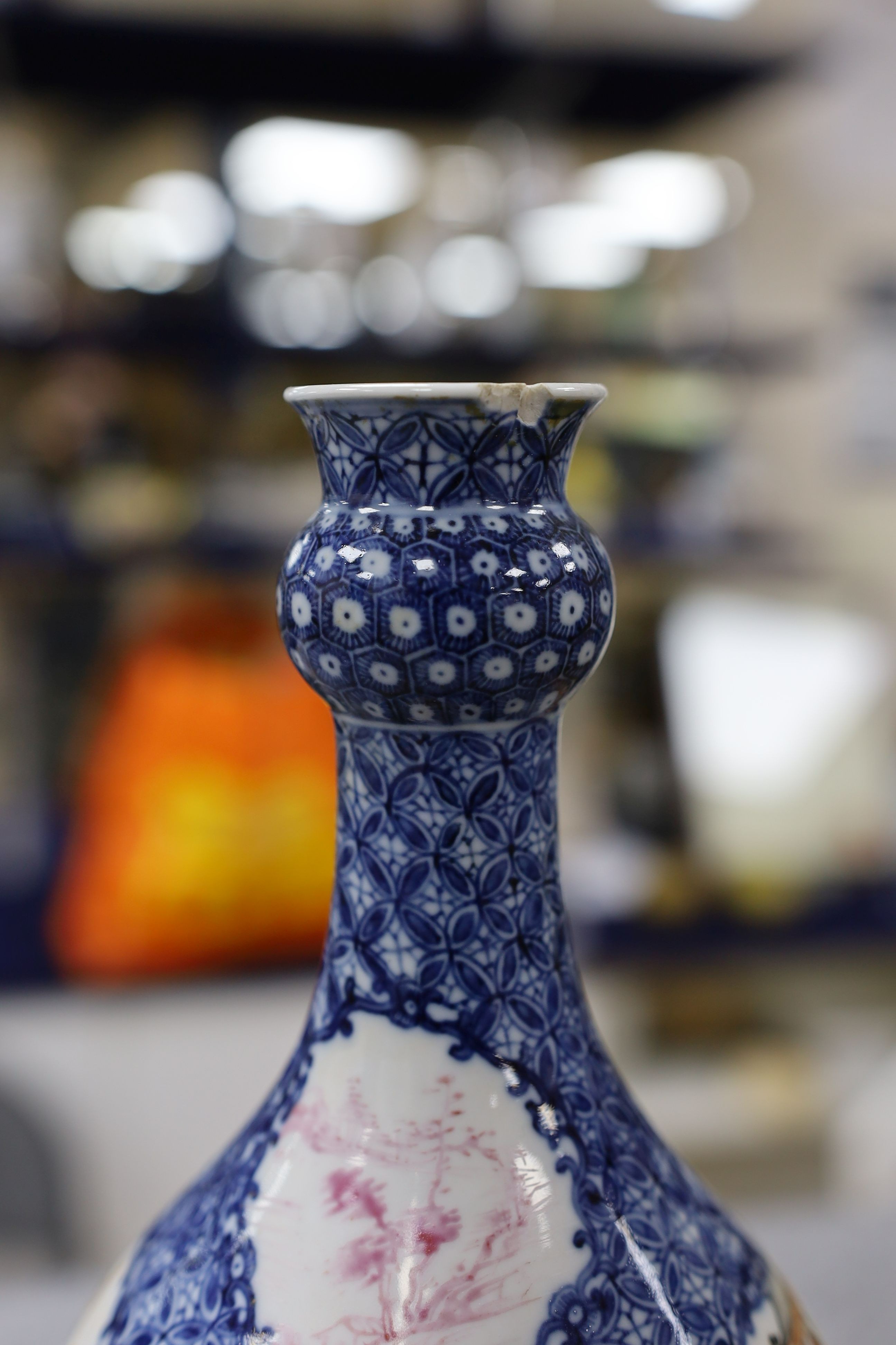 A pair Samson of Paris vases in the Chinese famille verte style and a Chinese Qianlong famille rose garlic neck vase with blue panelling motif, tallest 26cm